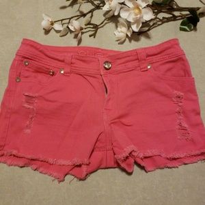 Pink denim shorts with jewel accents